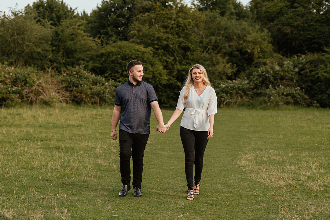Couple walk towards camera, pishiobury park engagement shoot
