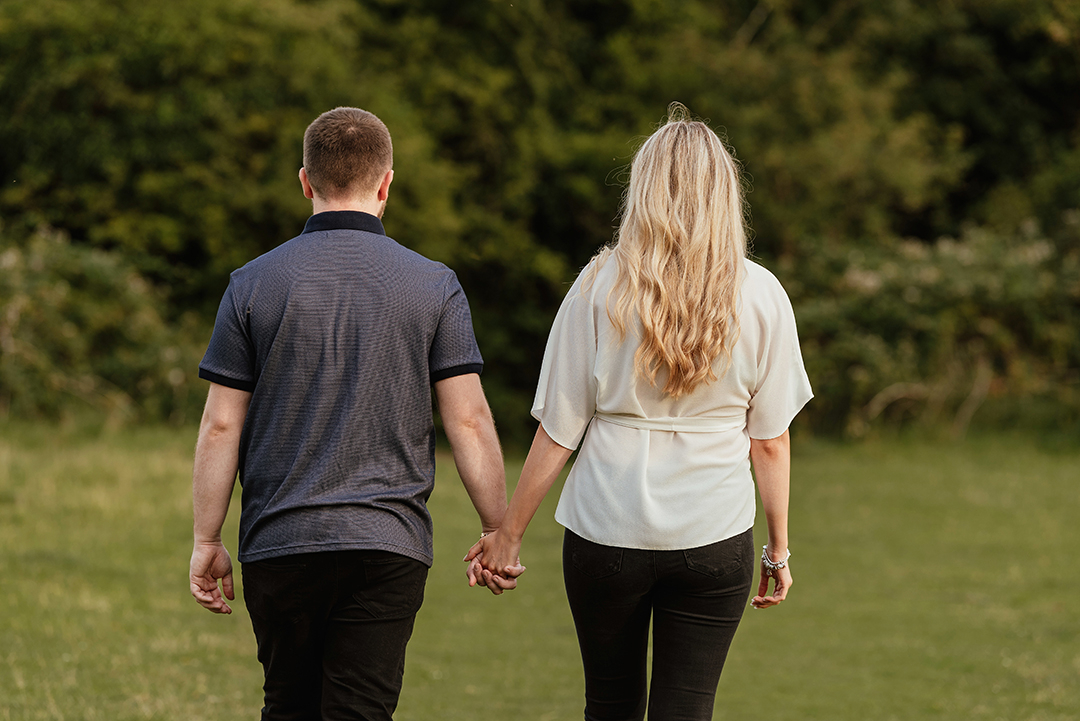 Couple walk away from camera, pishiobury park engagement shoot