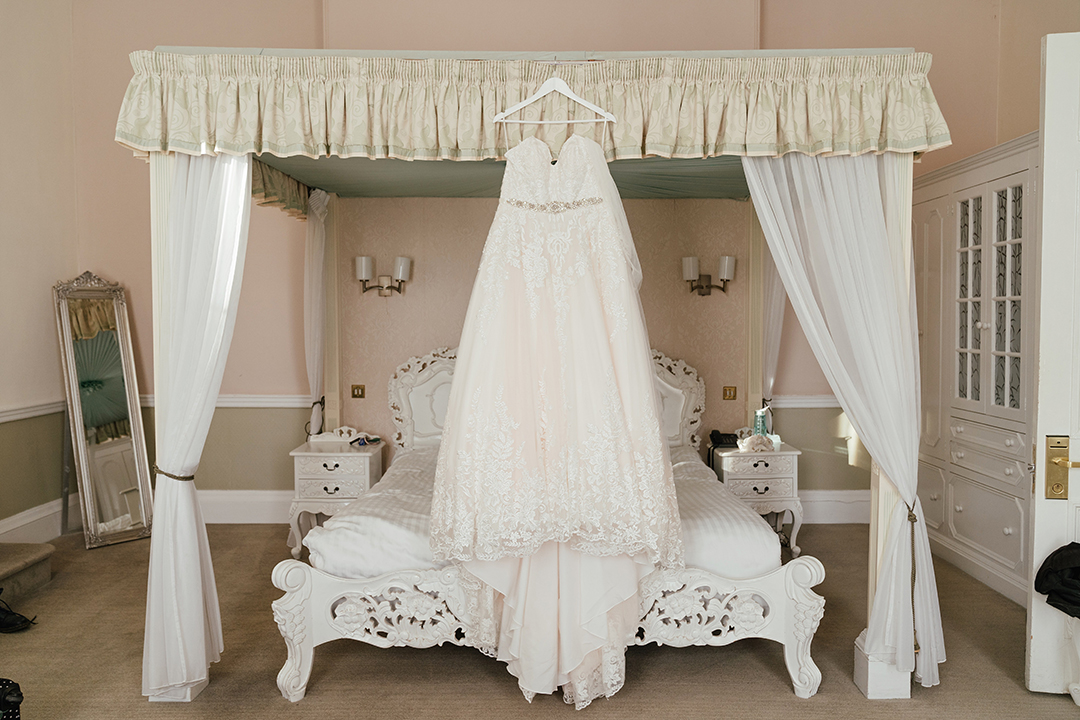 Wedding Dress Hanging On Four Poster Bed at Manor of Groves Wedding