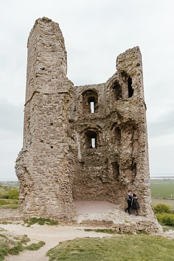 Couple against the castle remains at Hadleigh Castle