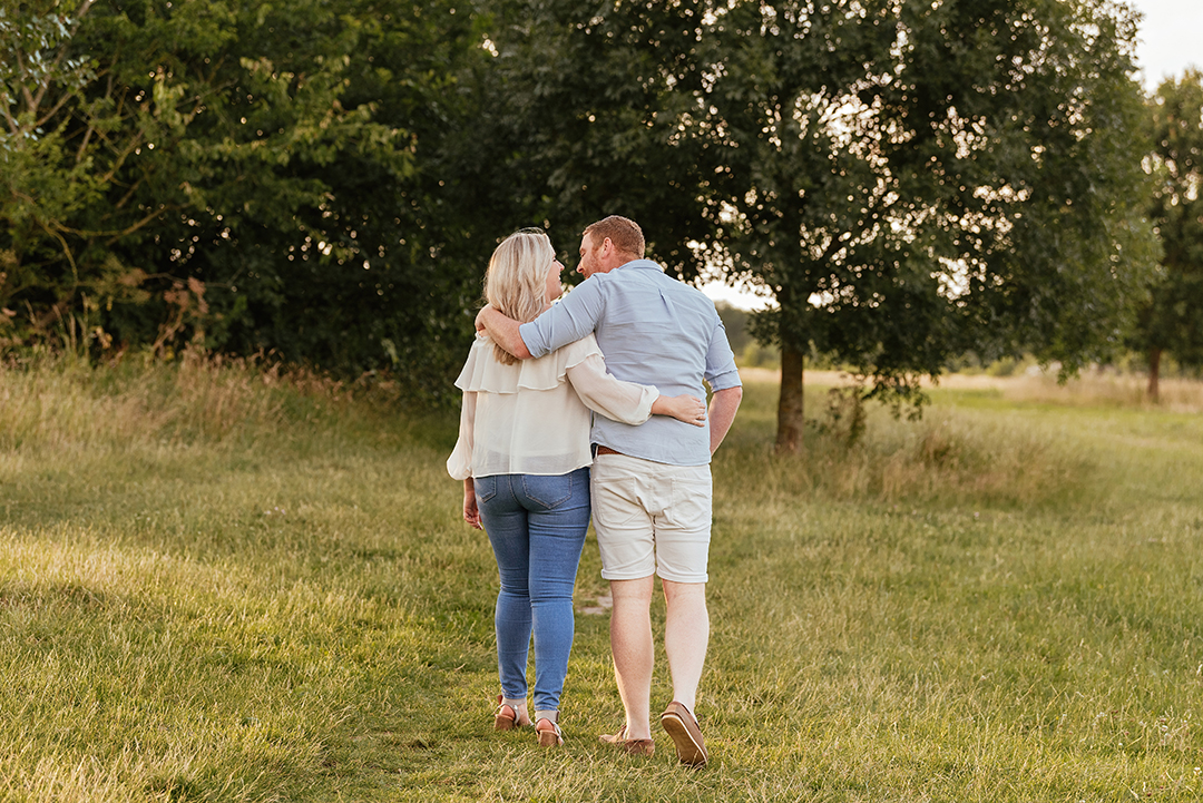 Couple walk away from the camera Hylands Park engagement session