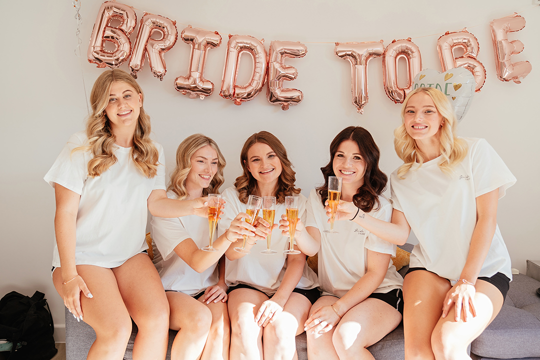 Bridesmaids Toast Under Bride to Be Balloons