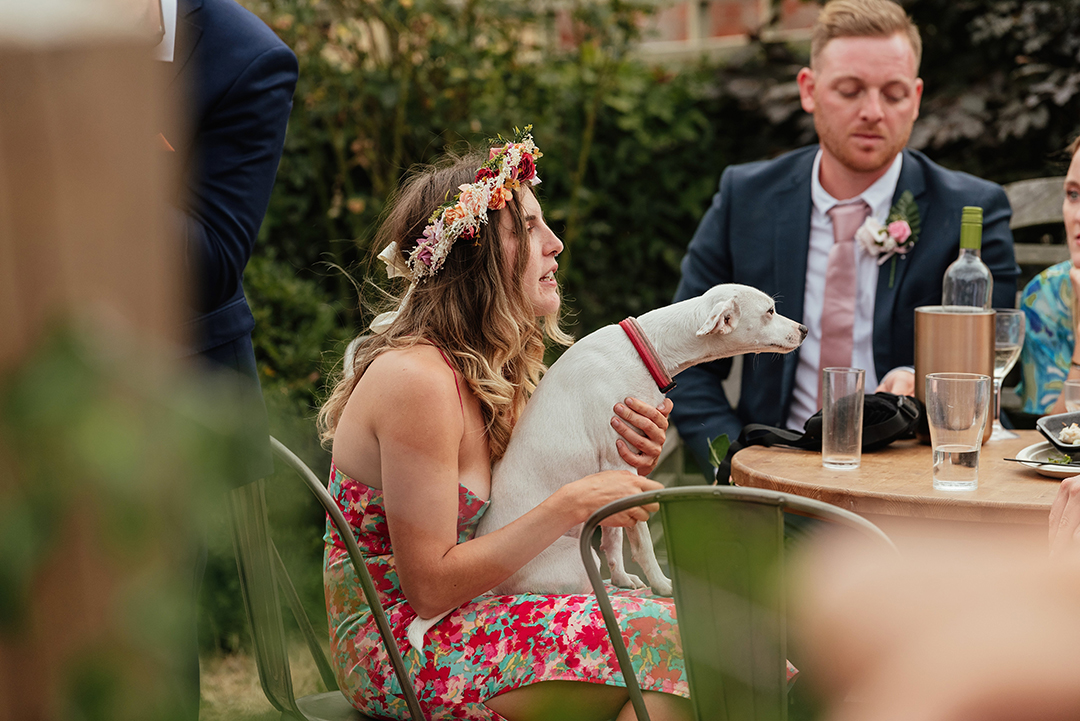 Wedding Guest with Dog On Lap Stock Street Farm Barn Wedding Photography