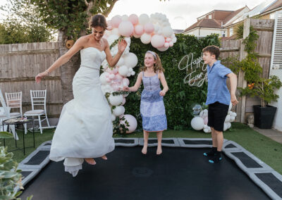 077 Wedding Moments 2022 - Bride on Trampoline Back Garden Wedding