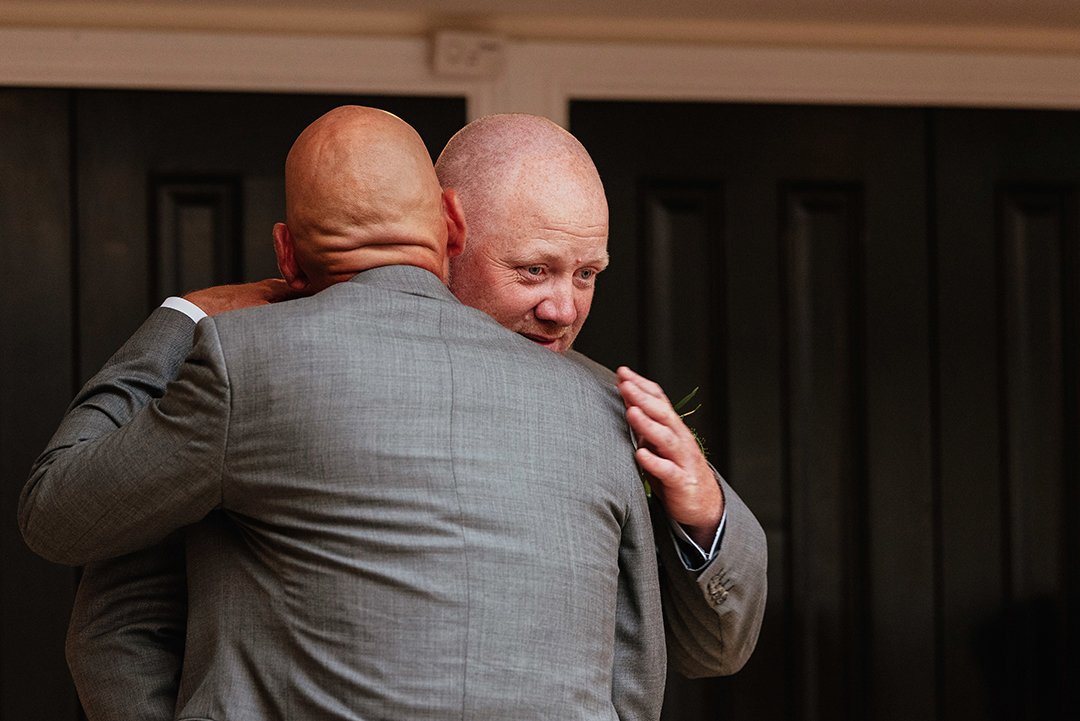 The Rayleigh Club Wedding Photography Groom and Best Man Embrace