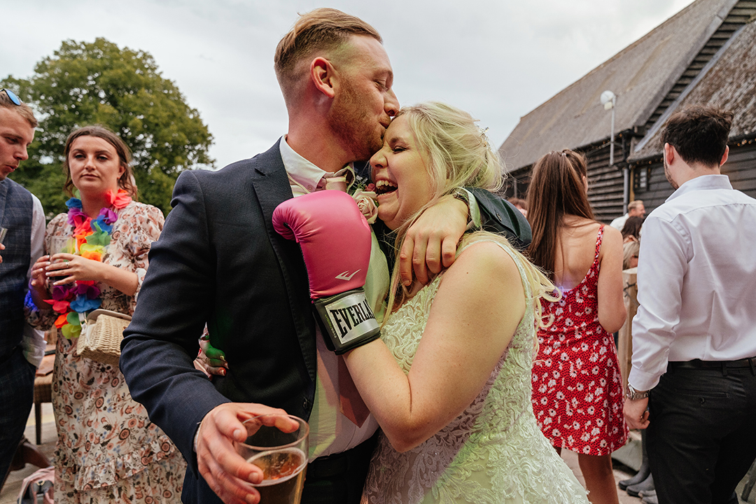 Bride embraces wedding guest Stock street Farm Barn Wedding