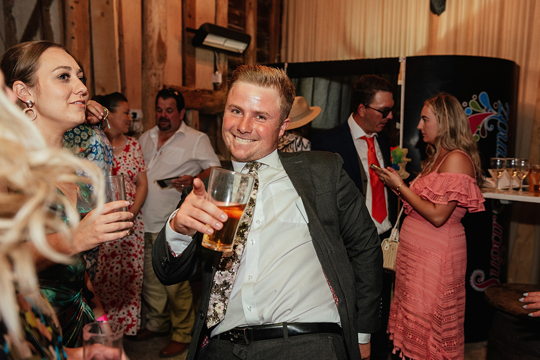 Wedding Guest Dancing with beer in hand at Stock Street Farm Barn Wedding Reception