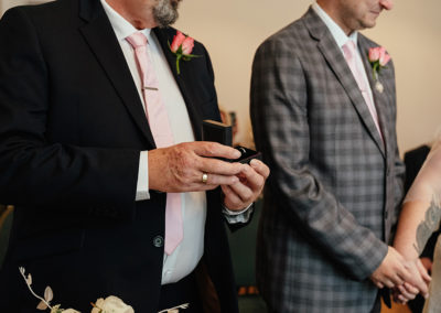 Close up of best man presenting the rings in Moot House Wedding Ceremony