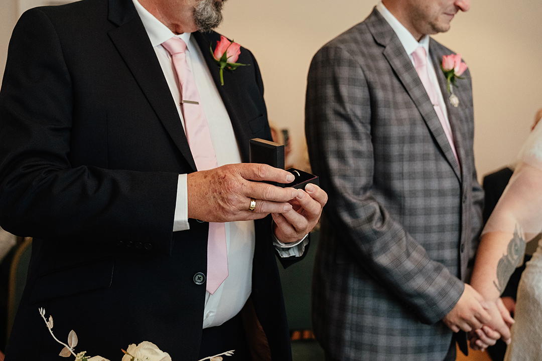 Close up of best man presenting the rings in Moot House Wedding Ceremony