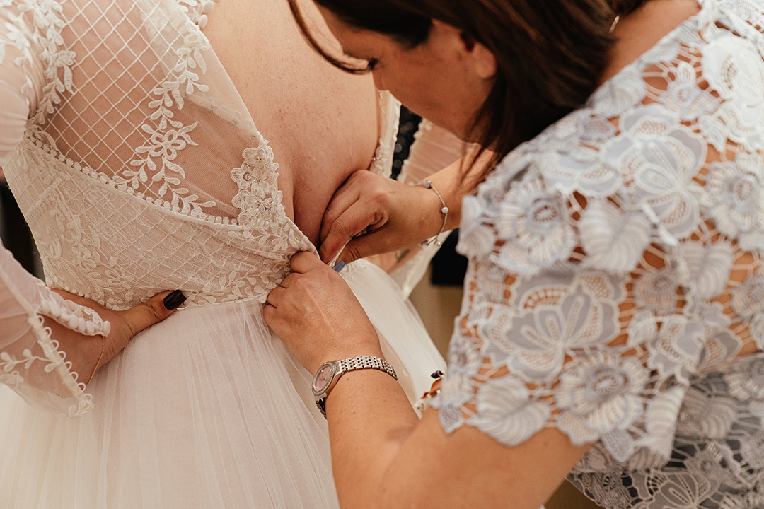 Mum Helps Bride into Dress Minstrel Court Wedding Photography