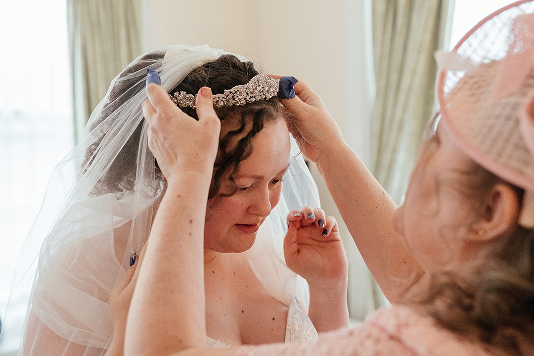 Mum Helps Bride Put On Wedding Tiara Manor of Groves Wedding