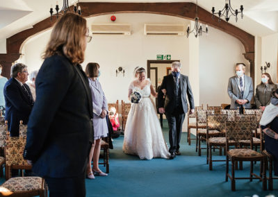 Bride walks in with her dad at Bishops Stortford Register Office wedding