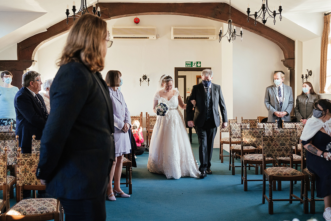 Bride walks in with her dad at Bishops Stortford Register Office wedding