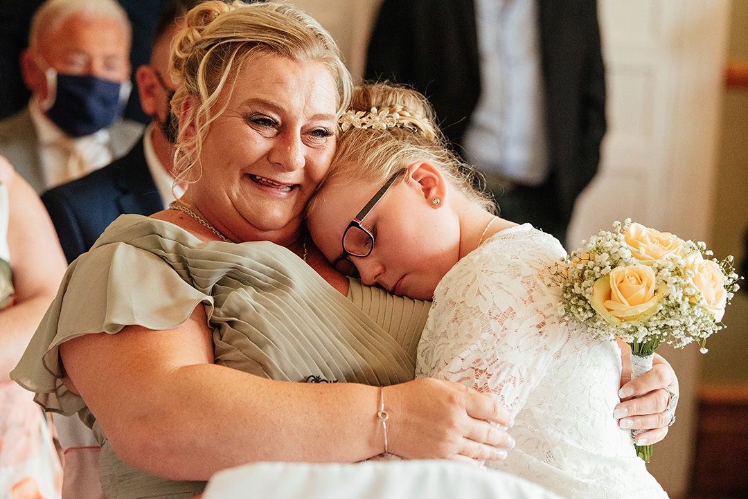 Hertfordshire Golf & Country Club Wedding Emotional Embrace between Bridesmaid and Flower Girl