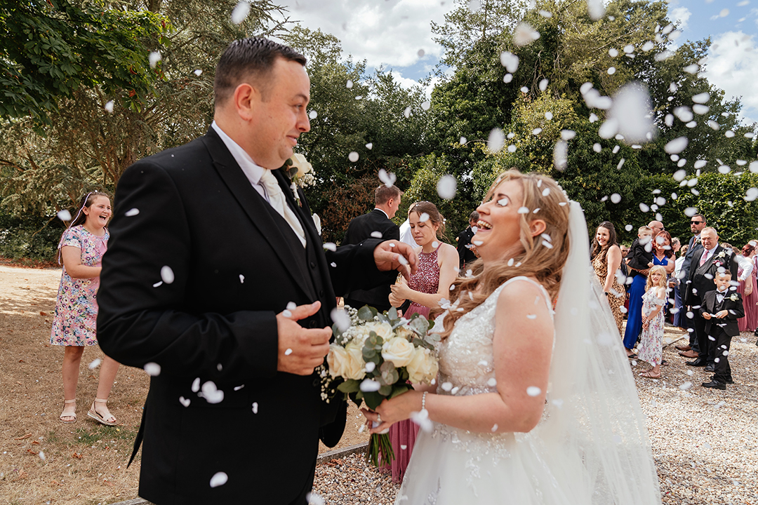 Bride and Groom Laugh as confetti falls Vaulty Manor Wedding Photography