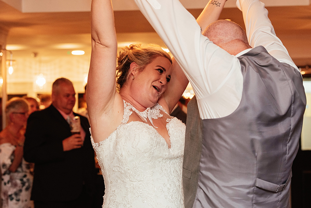 Husband and Wife Hold Hands up Dancing The Rayleigh Club Wedding Photography