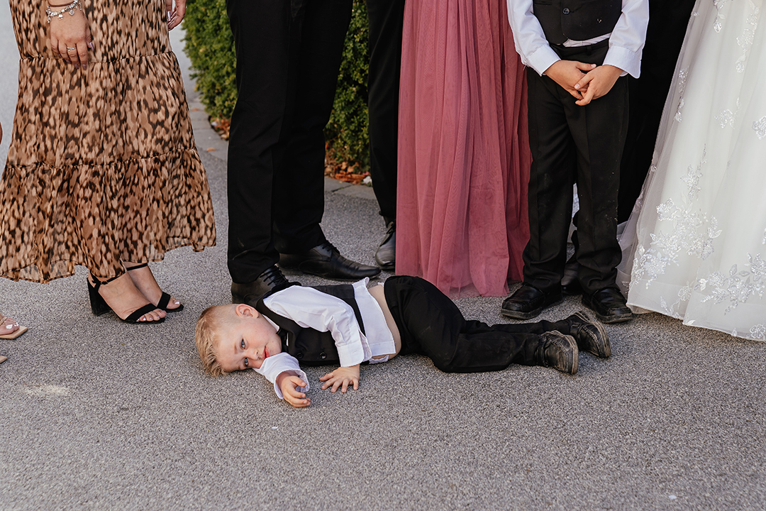 Young boy lays on floor Vaulty Manor Wedding Photography