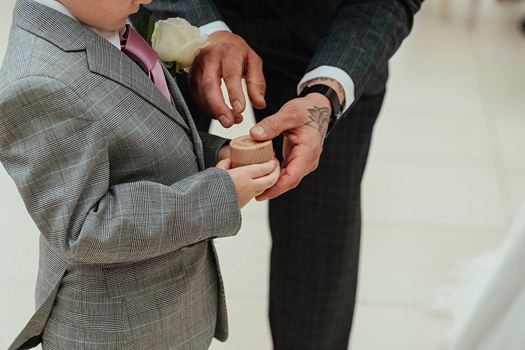 Ring Exchange Close Up of Son Giving Rings to Groom and Dad