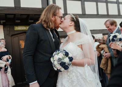 Couple stop and share kiss Bishops Stortford Register Office