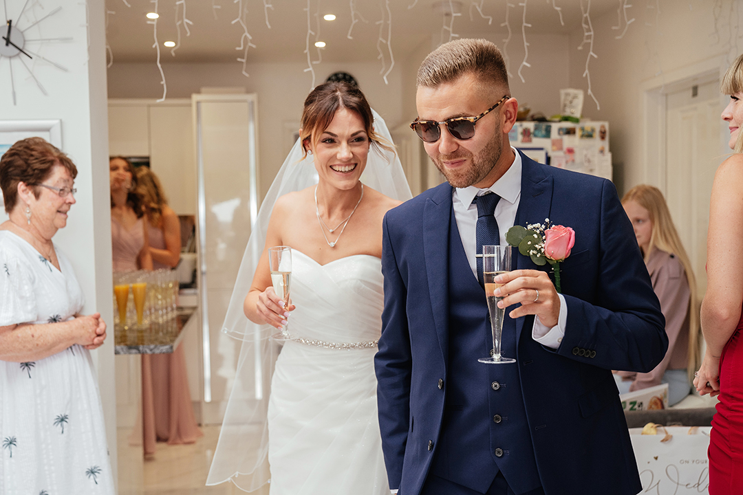 Couple Arrive at Reception Bubbles in Hand