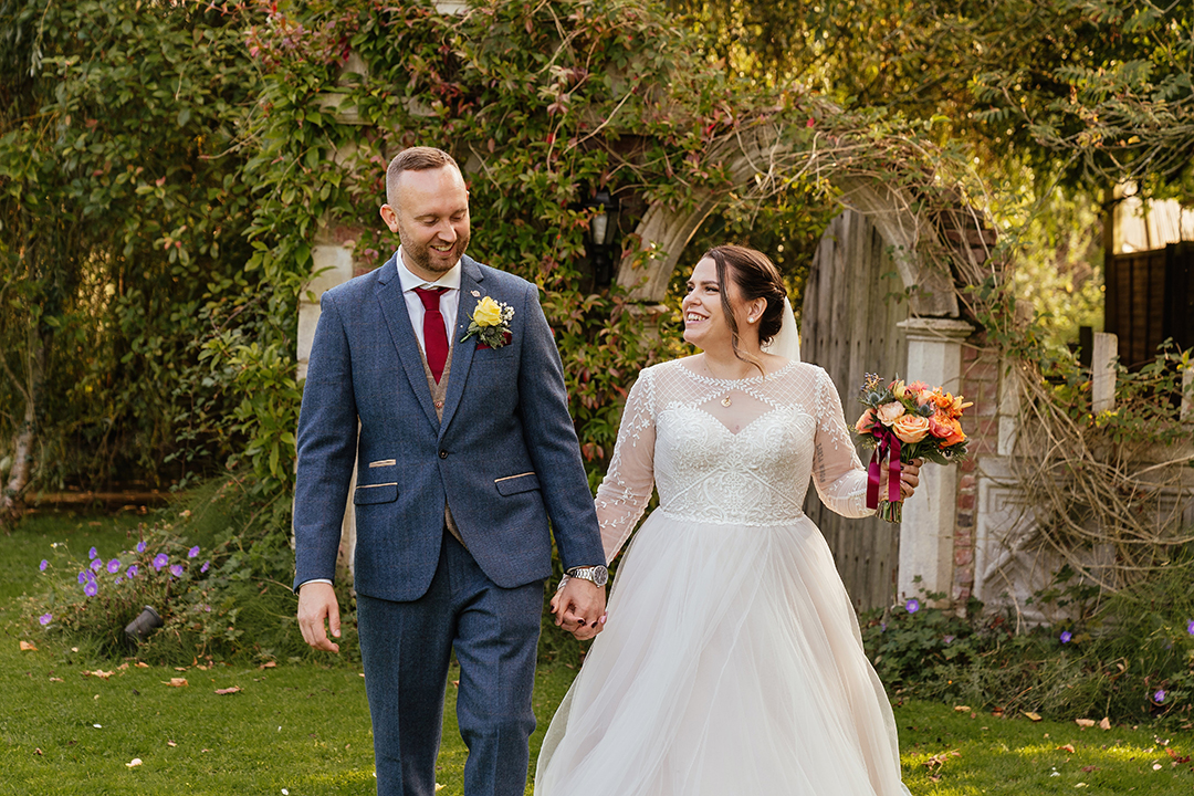 Natural moment between couple as they walk towards camera Minstrel Court Wedding Photography