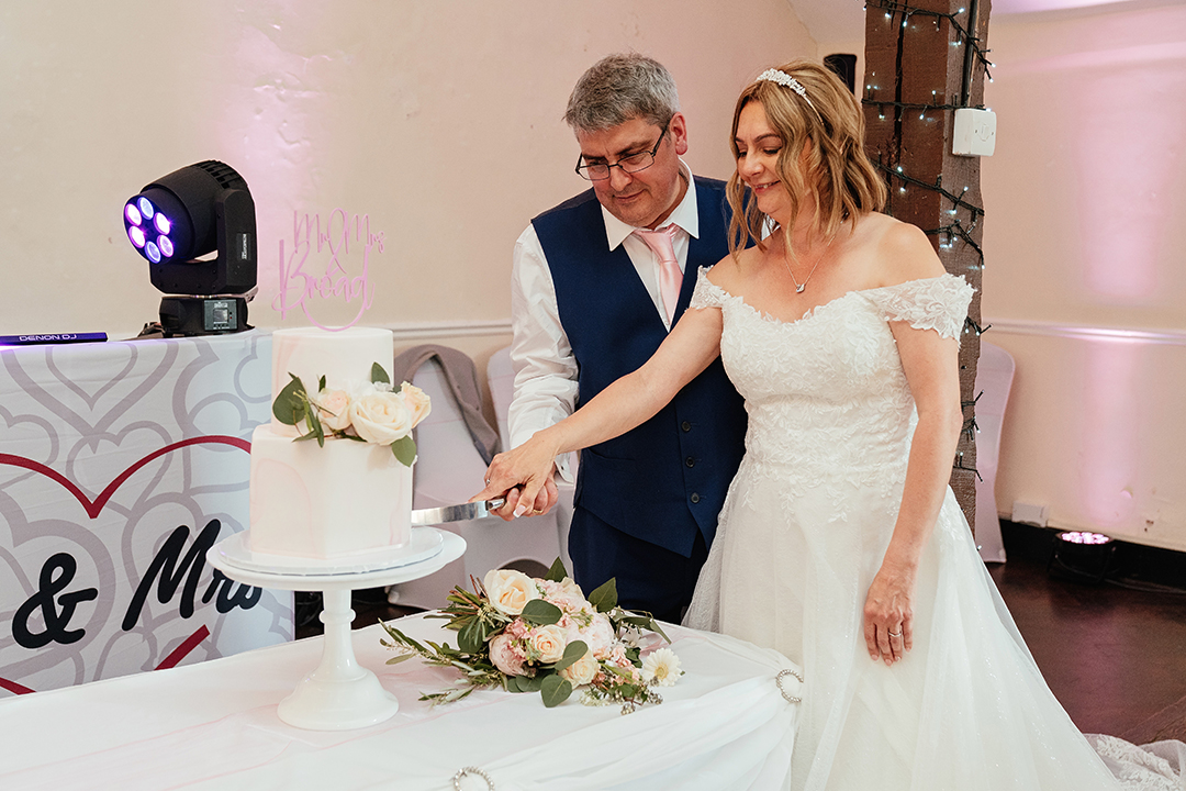 Couple Cutting Wedding Cake at Canons Brook Golf Club