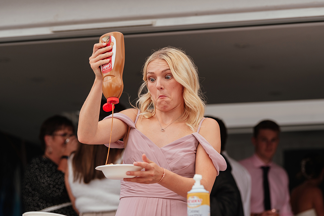 Bridesmaid Adding Sauce to her Waffle