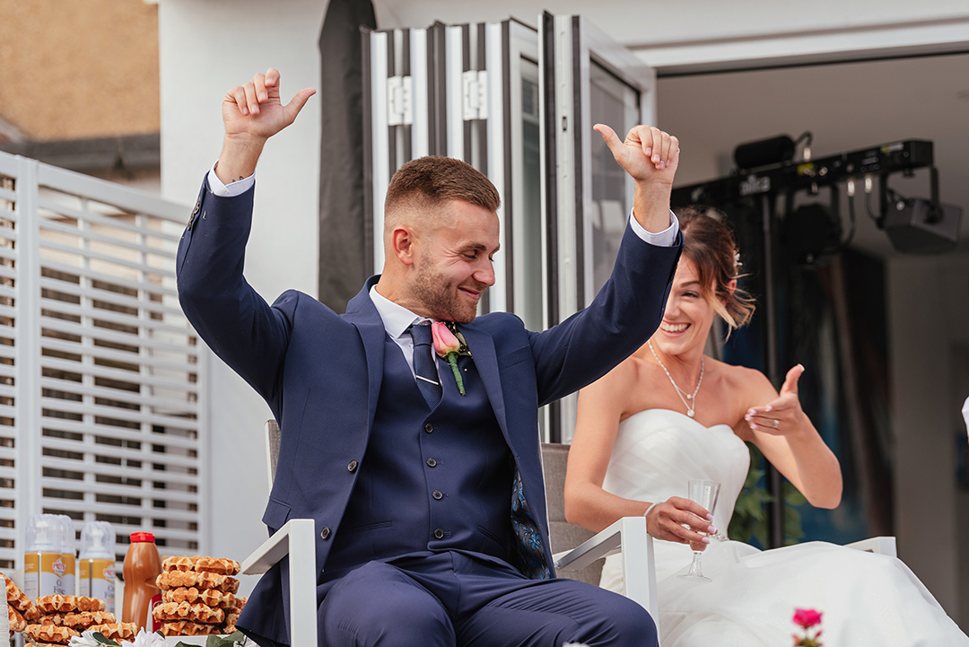 Groom Arms Up Reaction to Speeches Wedding Photography