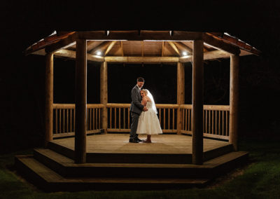 Bride and Groom under gazebo Night Time Couples Shot That Amazing Place Wedding Photography