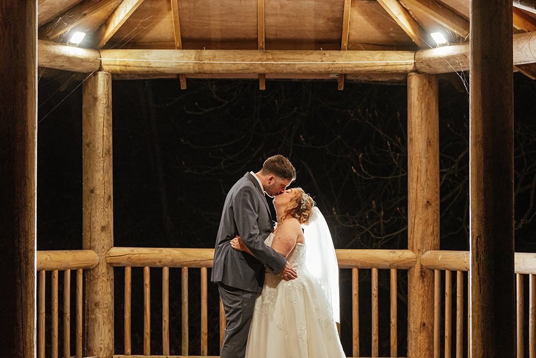 Bride and Groom Kiss under gazebo That Amazing Place Wedding Photography Night Time Couples Shot