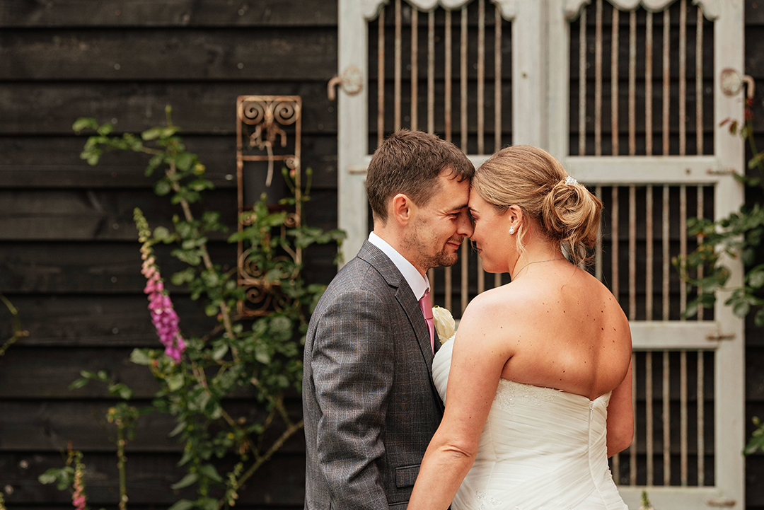 Couples Rest heads together romantically with backs to camera at Gaynes Park Wedding