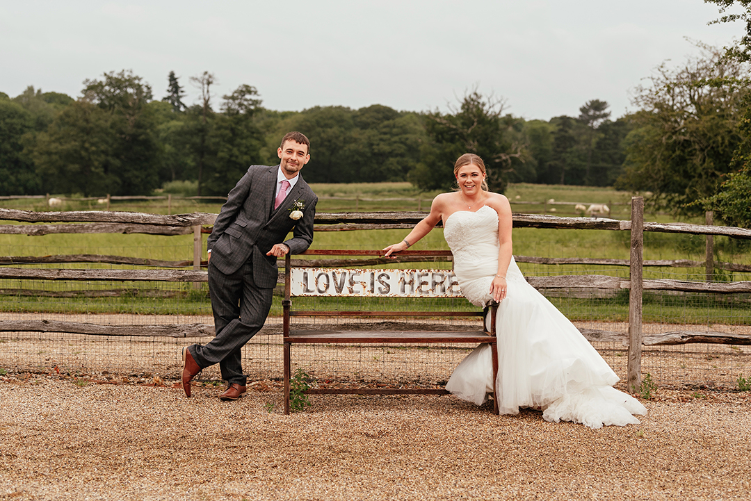 Couple Lean on Love is Here bench at Gaynes Park