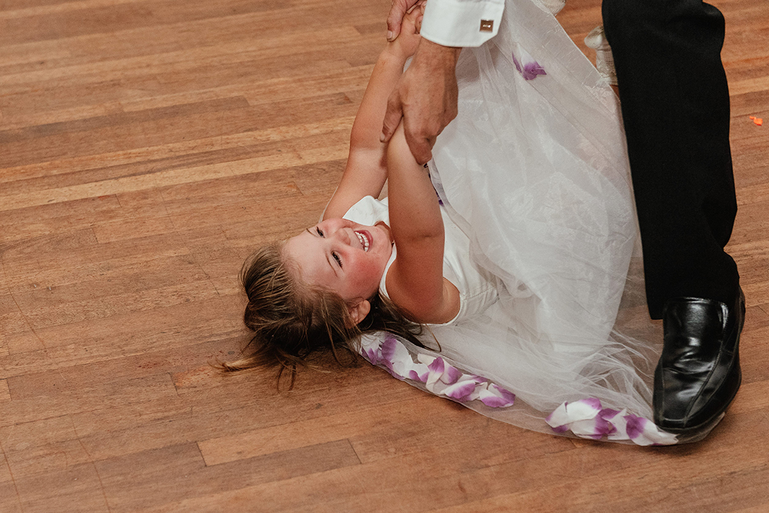 Flowergirl and Groom Playing Laughing Laying on Floor