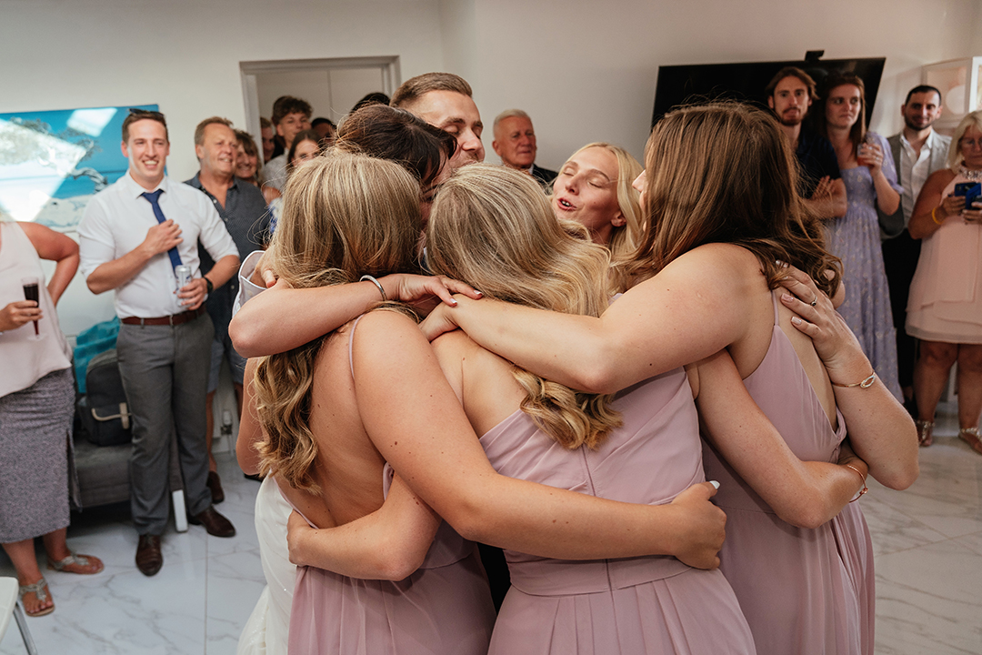 Couples and Bridesmaids Embrace on the Dancefloor