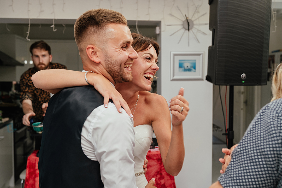 Couple Laughing at Wedding Guests Wedding Photography
