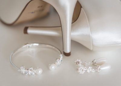 Bridal accessories laid with bridal shoes
