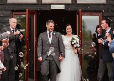 Bride and Groom walk through Bubbles Confetti Colville Hall Wedding Ceremony