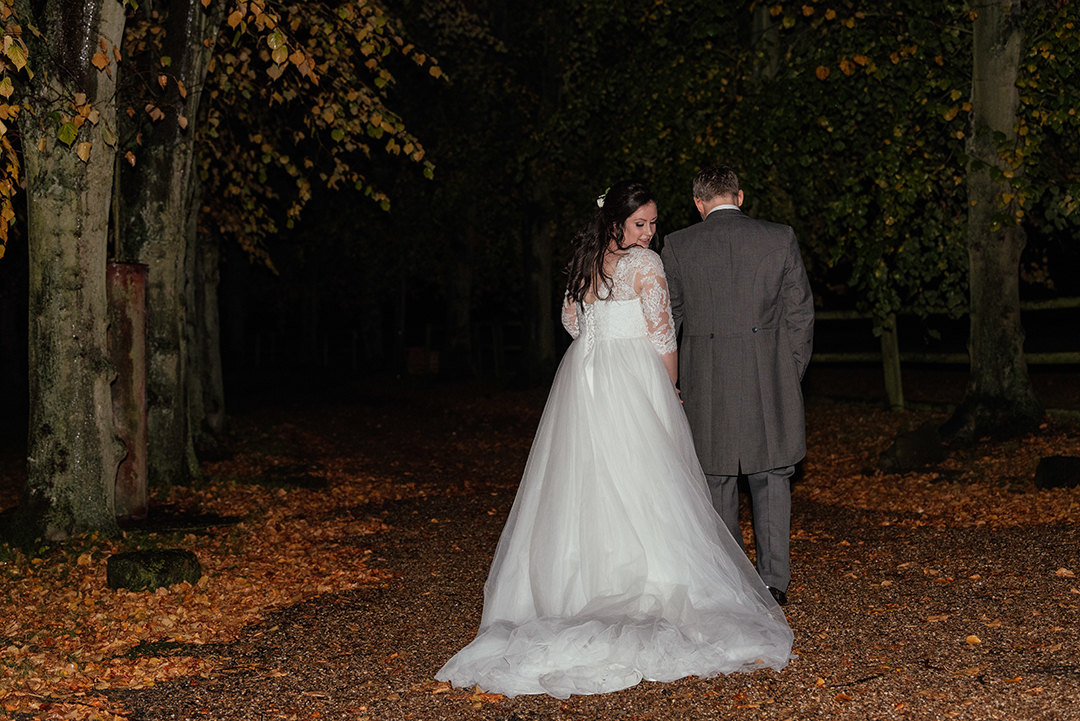 Night Portrait of Couple Walking Away from Camera in Autumn Colville Hall Wedding