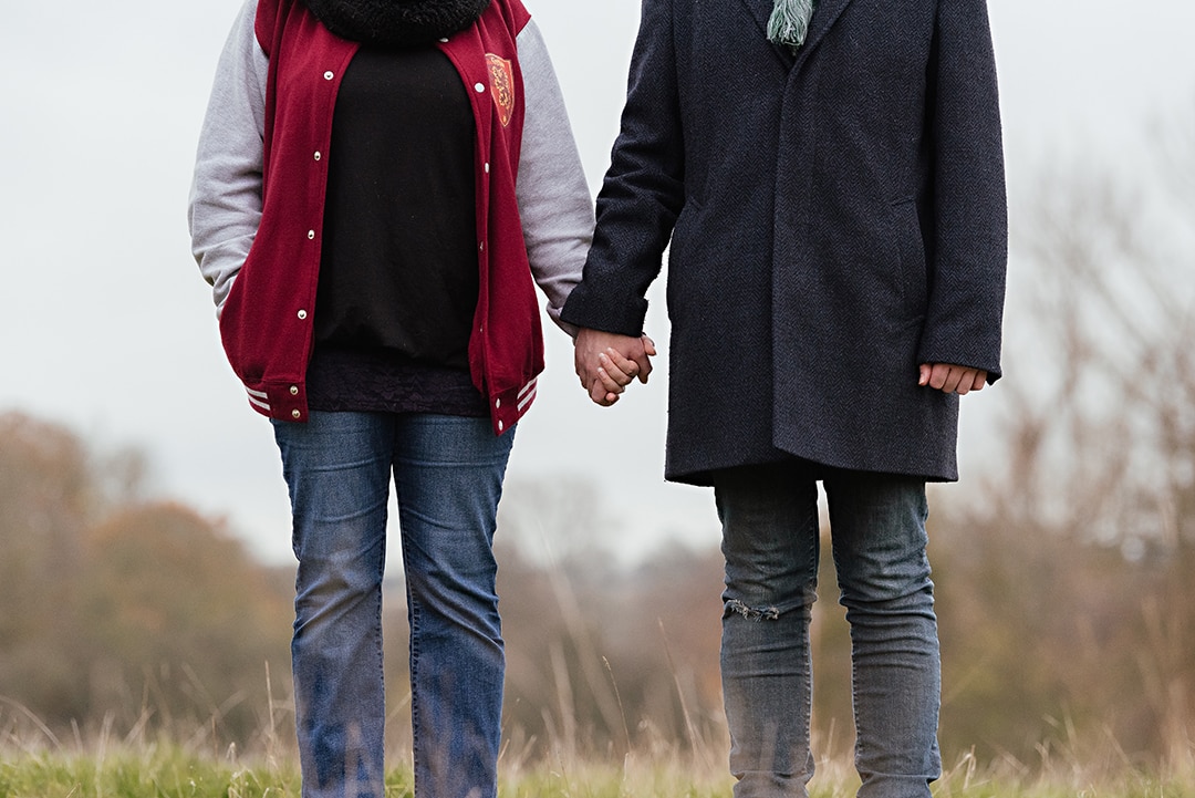 Couple hold hands in Harlow engagement photography session