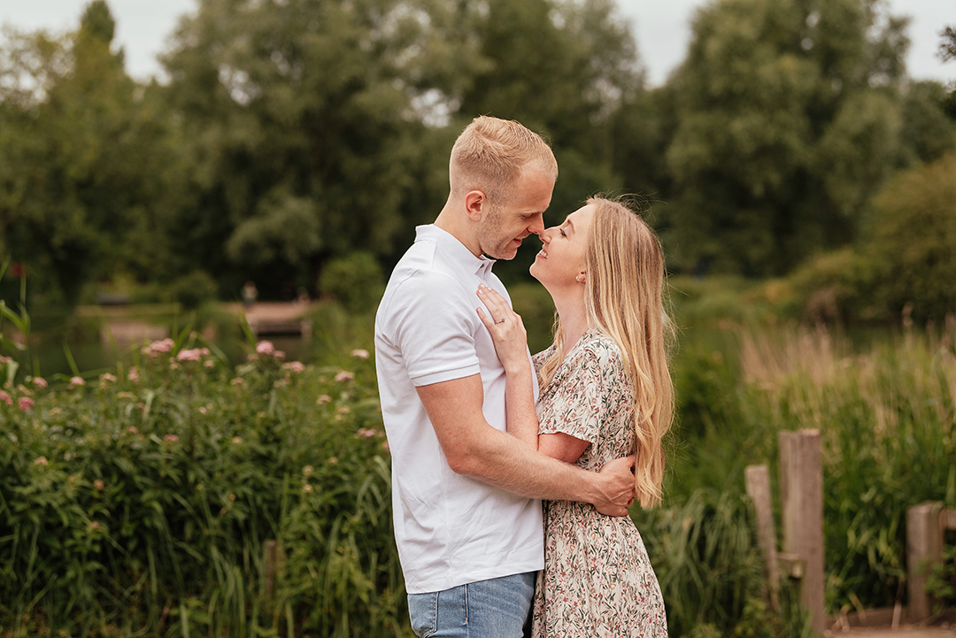 Couple lean in close together touching noses Engagement Photos at Stanborough Lake