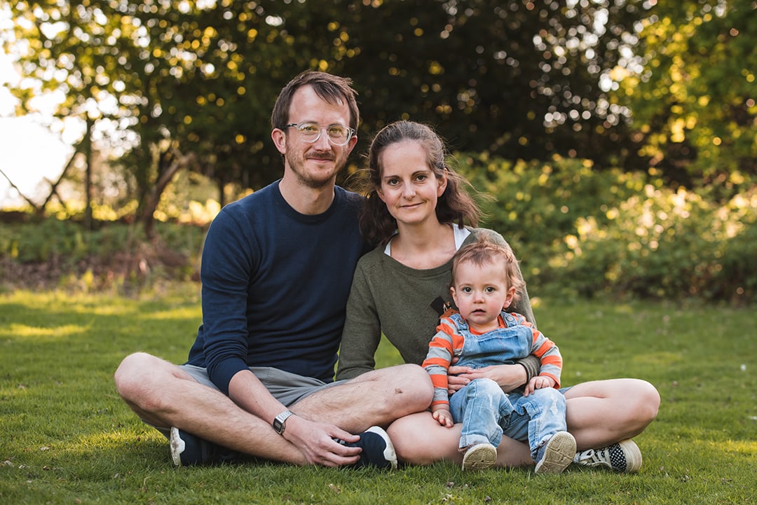 Family sit together for portrait at Park in Epping