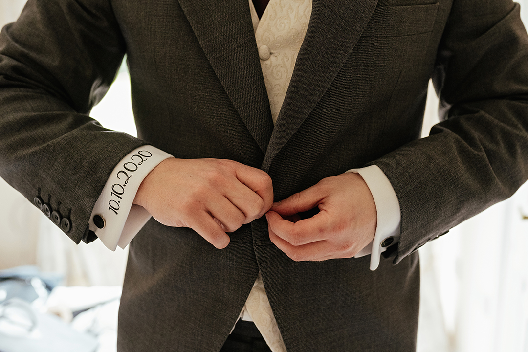 Groom Buttoning Suit Jacket at Colville Hall