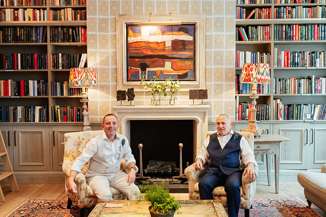 Grooms Sat together in Ham Yard Hotel Library