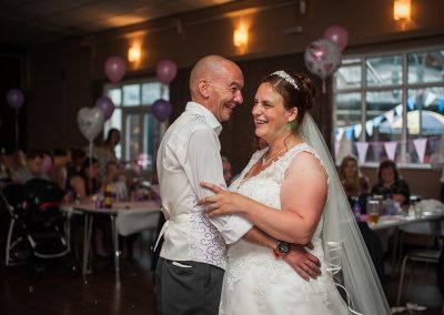 Natural photo of Couple embracing during First Dance at Harlow Wedding at the Moot House