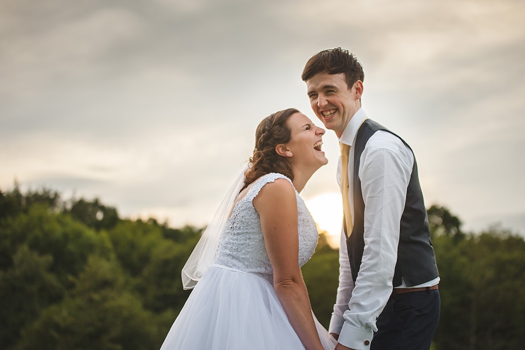 Natural Relaxed Couples Wedding Portrait laughing together at sunset