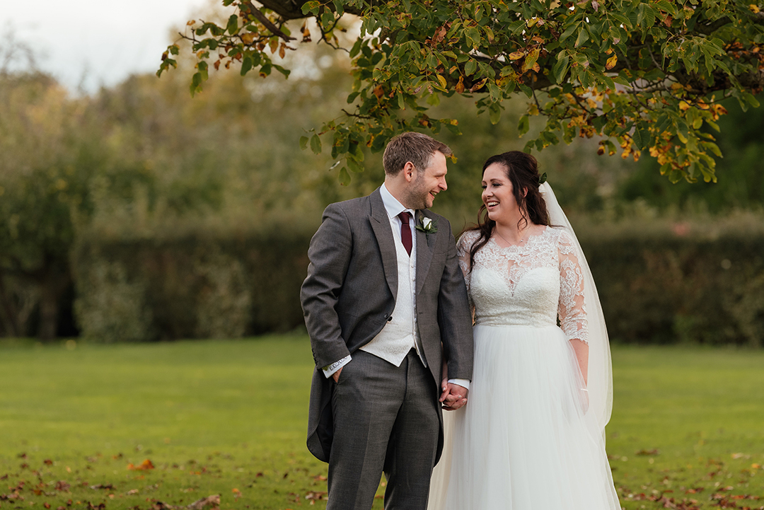 Natural shot of couple under Autumn leaves Wedding Photography Colville Hall