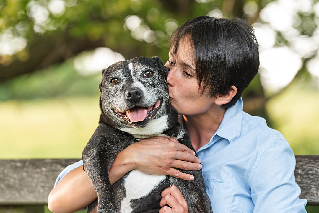 Owner kisses staffie in cute photo shoot