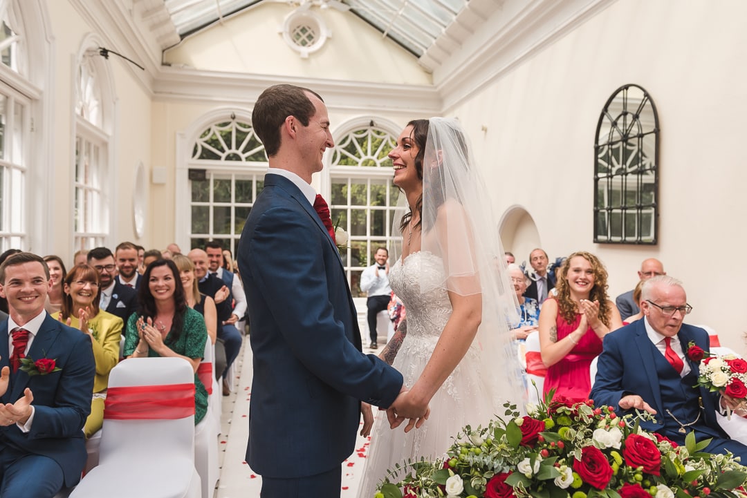 Couple look at each other lovingly in wedding ceremony at Hunton Park