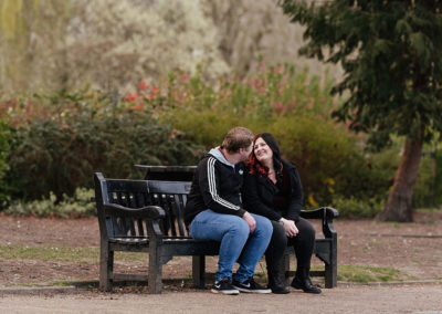 Engagement session, couple seated on bench, Castle Park Colchester