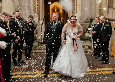 Bride and groom walk through confetti